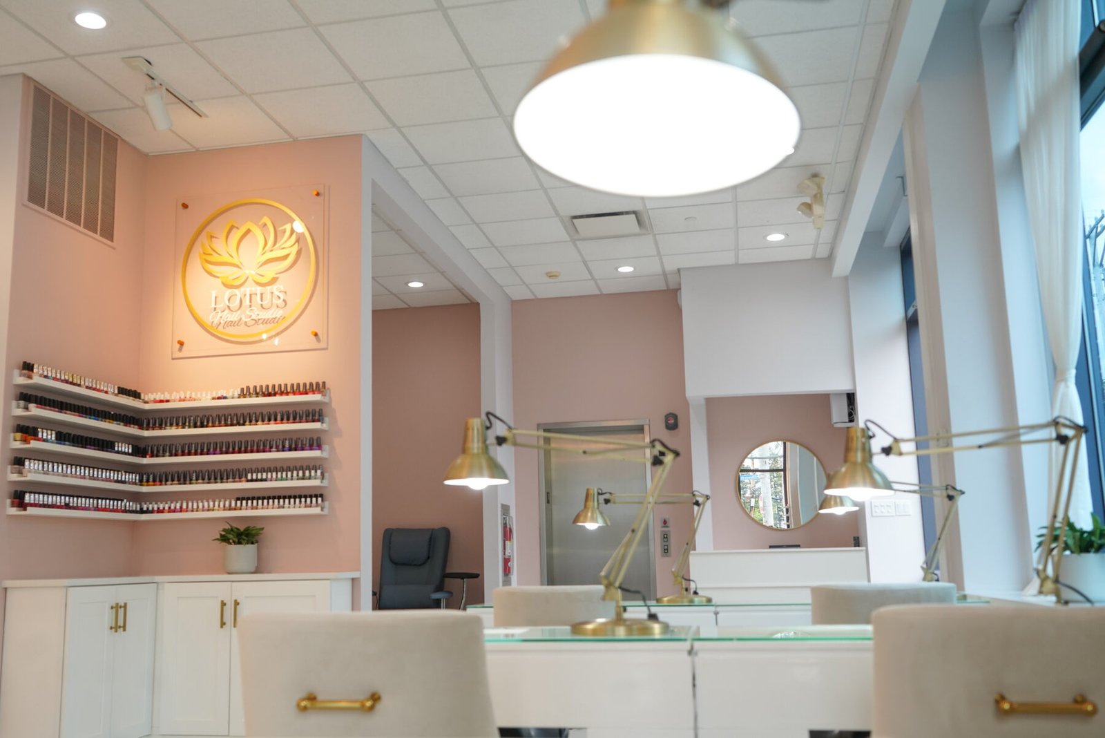 The illuminated Lotus sign above the polish wall at the studio