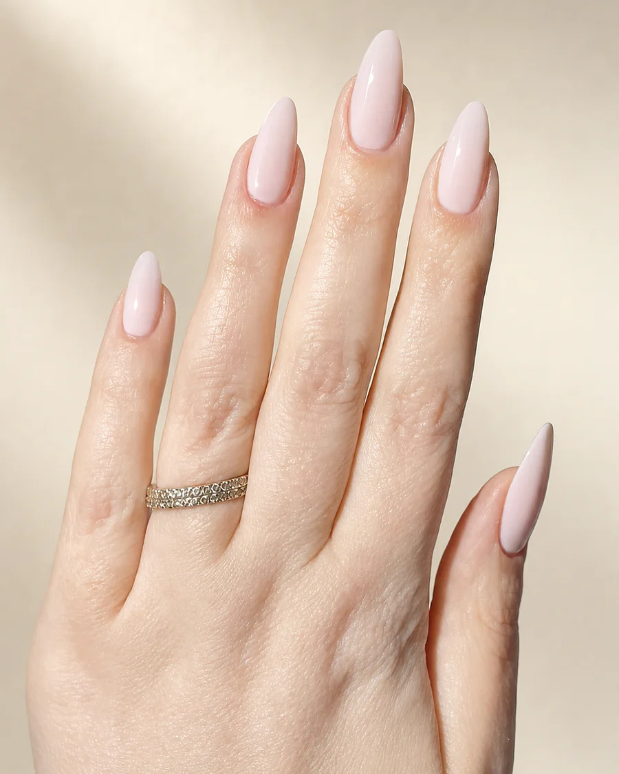 Pale blush almond nails with a diamond eternity ring