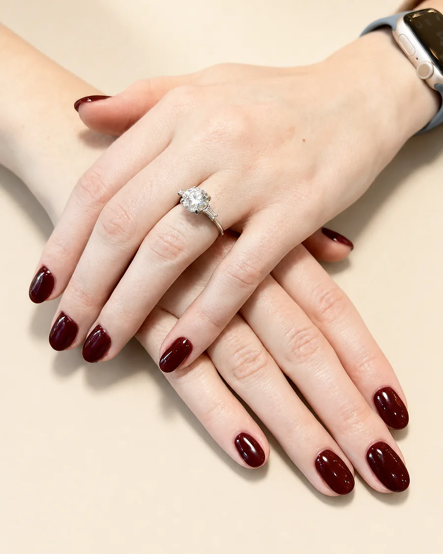 A deep burgundy gel finish on squoval nails