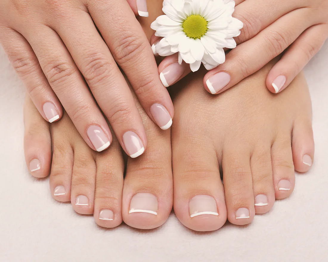 A finished French pedicure, toes shaped and polished