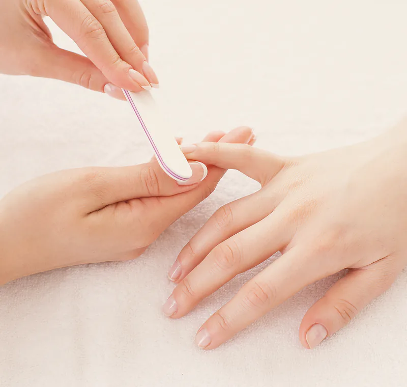 A hard gel overlay being filed to shape